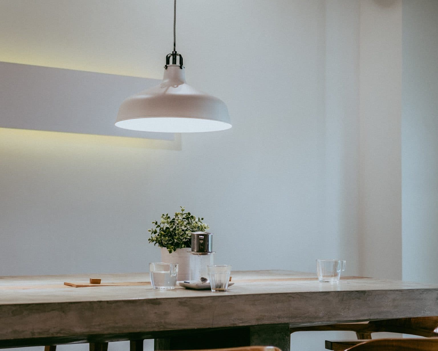 Pendant light fixture installed above a dining table